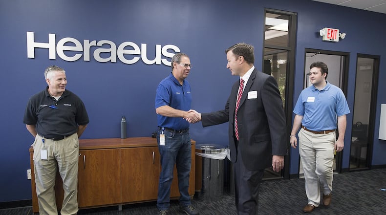 Gwinnett County principals and district leaders (right) are greeted by Heraeus employees (left) during a field trip to Heraeus in Buford, Thursday, June 13, 2019. For the third year, Gwinnett County Public Schools is partnering with area businesses to host its Principal Field Trip. This year, 60 school system leaders (high school and middle school principals, as well as a few district leaders) will participate, getting a firsthand look into the world of business and industry within Gwinnett County. ALYSSA POINTER/ALYSSA.POINTER@AJC.COM