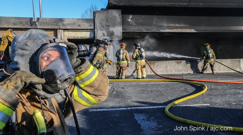 Fire crews continue to battle smoking debris at site of I-85 collapse Friday, March 31, 2017, in Midtown Atlanta.