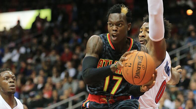 102715 ATLANTA: -- Hawks Dennis Schroder passes off driving the lane against Pistons Andre Drummond during the first period in their first regular season basketball game "home opener" on Tuesday, Oct. 27, 2015, in Atlanta. Curtis Compton / ccompton@ajc.com