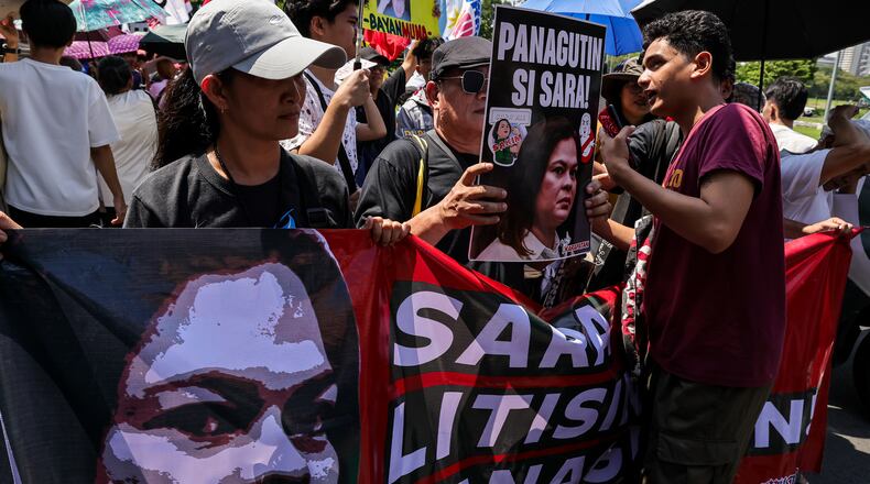 Protesters carry a banner calling for the impeachment of Philippine Vice President Sara Duterte during a protest in front of the Senate in Pasay, Philippines, Monday, July 6, 2026. (AP Photo/Gerard Carreon)