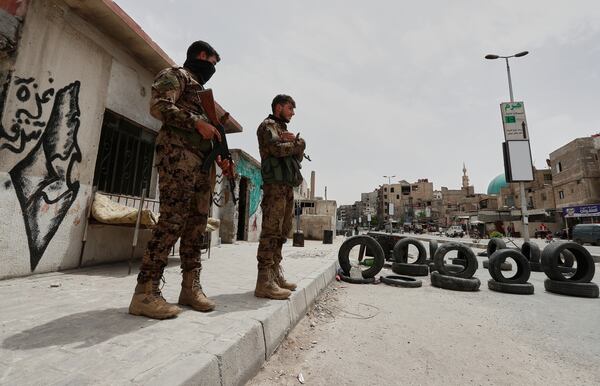 Syrian government security forces stand guard on their checkpointat one of Jaramana suburb entrances, after clashes in the area between members of the minority Druze sect and pro-government fighters, in the southern suburb of Jaramana, Damascus, Syria, Wednesday, April 30, 2025. (AP Photo/Omar Sanadiki)