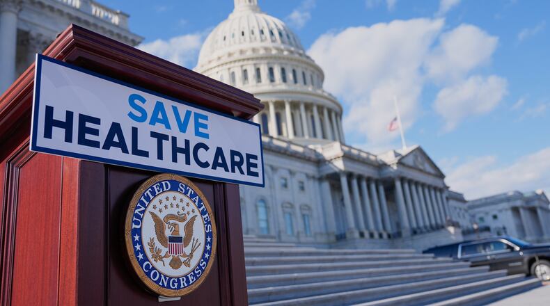 A podium is prepared before Democrats hold news conference on the health care funding fight on the steps of the House before votes to end the government shutdown, on Capitol Hill, Wednesday, Nov. 12, 2025, in Washington. (AP Photo/Mariam Zuhaib)