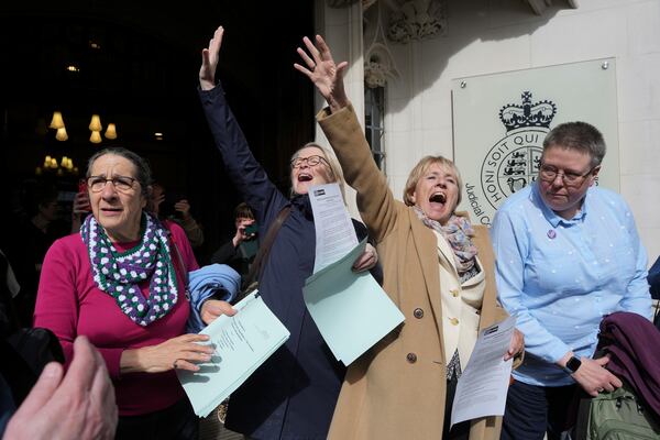 Women's rights activists celebrate outside the Supreme Court to challenge gender recognition laws, in London, Wednesday, April 16, 2025. (AP Photo/Kin Cheung)