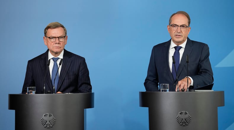 Germany's Interior Minister Alexander Dobrindt and Germany's Foreign Minister Johann Wadephul speak to the media during a press conference in Berlin on Tuesday, Sept. 1, 2026, about the attempted attack on Leipzig/Halle Airport last month with a drone loaded with explosives.(AP Photo/Ebrahim Noroozi)