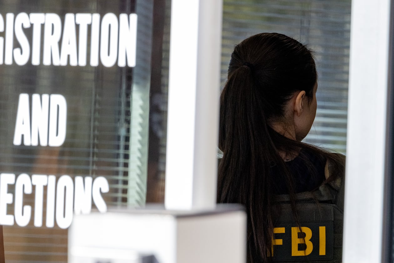 An FBI agent appears at the entrance to the Fulton County Election Hub and Operation Center in Union City on Wednesday, Jan. 28, 2026. (Arvin Temkar/AJC)