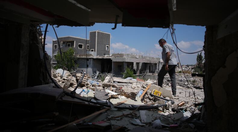 A resident inspects the damage to his home, destroyed in an Israeli airstrike during the Israel-Hezbollah war in Ghandouriyeh village, southern Lebanon, Tuesday, July 21, 2026. (AP Photo/Hassan Ammar)