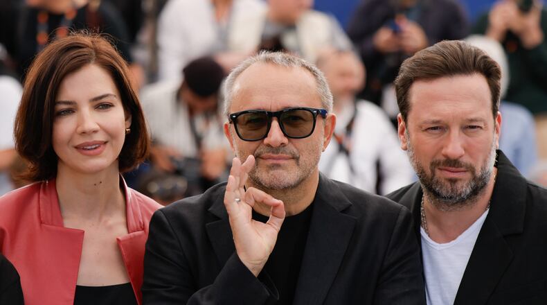 Iris Lebedeva, director Andrey Zvyagintsev and Dmitriy Mazurov pose for photographers at the photo call for the film Minotaur' at the 79th international film festival, Cannes, southern France, Wednesday, May 20, 2026. (Photo by Millie Turner/Invision/AP)