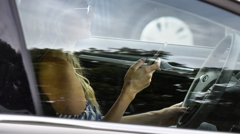 WSB-Radio will answer questions about Georgia's distracted driving law from 11 a.m. to noon today. HYOSUB SHIN / HSHIN@AJC.COM