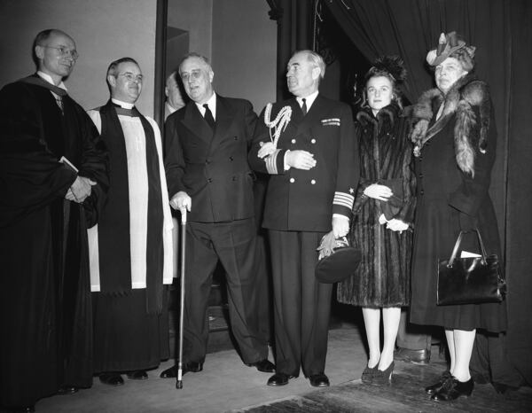FILE - President Franklin D. Roosevelt, takes the arm of Capt. John L. McCrae, the president's Naval aide, as he leaves the Church of the Epiphany in Washington on Dec. 25, 1942, after attending Christmas church services accompanied by first lady Eleanor Roosevelt, right, and their daughter Ethel. (AP Photo/George R. Skadding)
