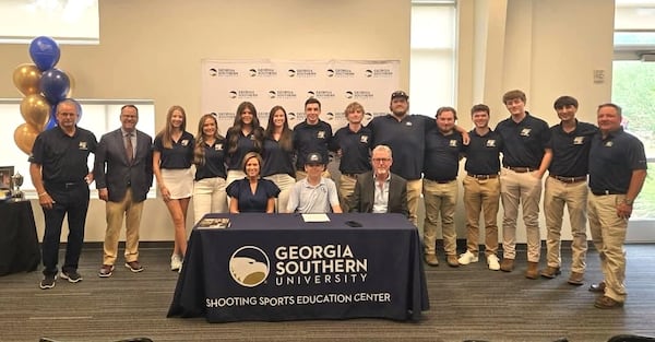 Connor Daniel, the top U.S. junior sporting clays shooter, sits between his parents, Cindy Daniel and Marty Daniel, at his signing ceremony with Georgia Southern University earlier this year. (Courtesy of Georgia Southern University)