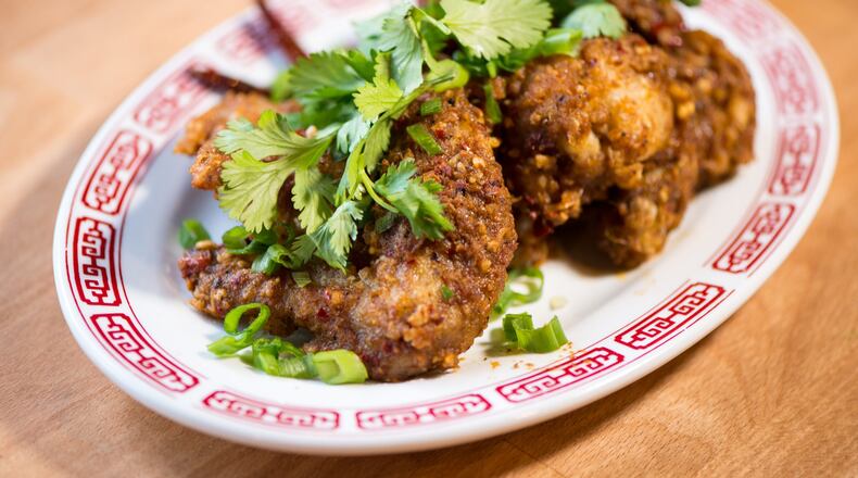 Double Dragon Chongqing Chicken Wings with sichuan peppercorns, dried chilies, scallions, cilantro. / Photo credit- Mia Yakel.