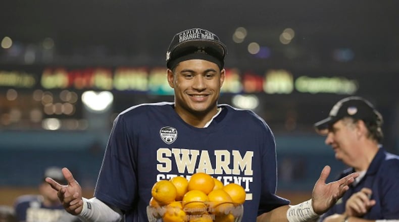 Georgia Tech quarterback Justin Thomas poses with his MVP trophy after the Jackets defeated Mississippi State 49-34 in the Orange Bowl. Coach Paul Johnson is on the right. (AP Photo/Wilfredo Lee, File)