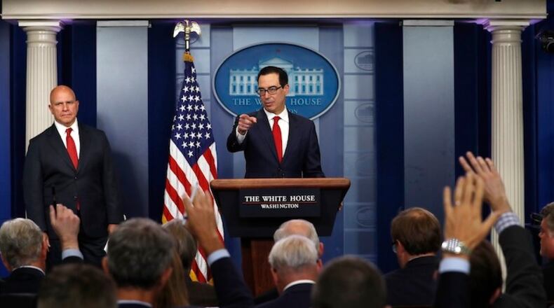 Treasury Secretary Steven Mnuchin, joined by national security adviser H.R. McMaster, left, speaks during the news briefing at the White House, in Washington, Friday, Aug. 25, 2017. (AP Photo/Carolyn Kaster)