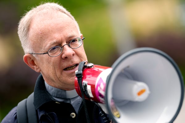 FILE - Priest Joerg Alt addresses supporters prior to the beginning of his trial at a court in Munich, Germany, May 3, 2023. (AP Photo/Matthias Schrader, File)
