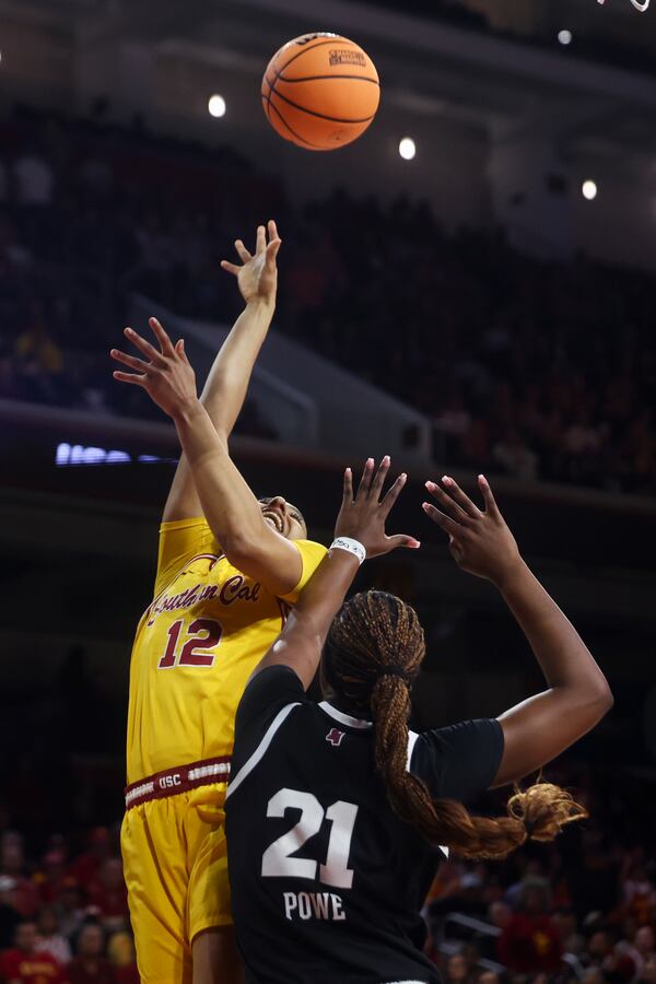 Southern California guard JuJu Watkins (12) draws a foul against Mississippi State guard Debreasha Powe (21) during the first half in the second round of the NCAA college basketball tournament Monday, March 24, 2025, in Los Angeles. (AP Photo/Jessie Alcheh)