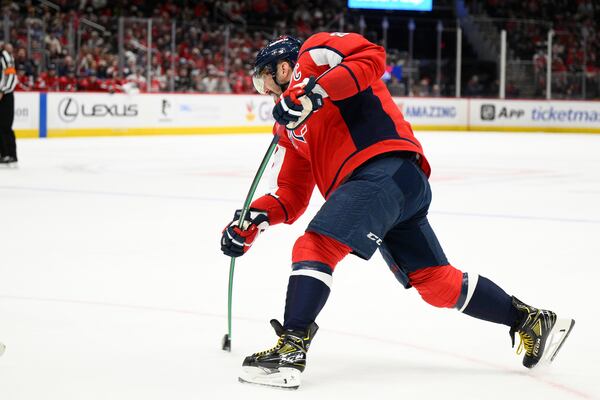 Washington Capitals left wing Alex Ovechkin (8) shoots during the first period of an NHL hockey game against the Buffalo Sabres, Sunday, March 30, 2025, in Washington. (AP Photo/Nick Wass)