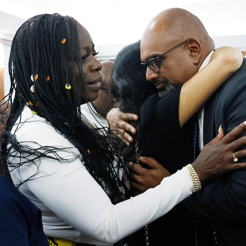 Friends and family members of rapper Tupac Shakur, including his sister Sekyiwa Shakur, second left, line up to hug Chief Deputy District Attorney Binu Palal, right, after a jury found Duane Davis guilty of first-degree murder in his trial related to the 1996 killing of rapper Tupac Shakur, at Clark County District Court Regional Justice Center, Monday, Aug. 31, 2026, in Las Vegas. (Bizuayehu Tesfaye/Las Vegas Review-Journal via AP, Pool)