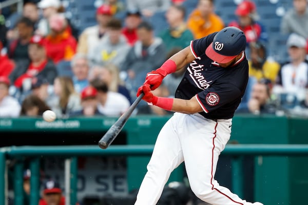 Washington Nationals' Keibert Ruiz hits a double against Atlanta Braves pitcher AJ Smith-Shawver during the first inning of a baseball game in Washington, Thursday, May 22, 2025. (AP Photo/Terrance Williams)