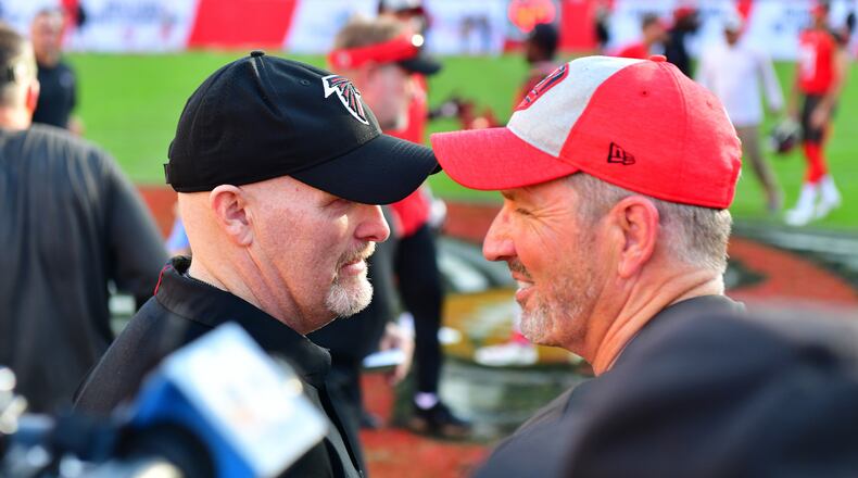 Head coach Dirk Koetter of the Tampa Bay Buccaneers congratulates head coach Dan Quinn of the Atlanta Falcons after a 34-32 falcons win at Raymond James Stadium on December 30, 2018 in Tampa, Florida. (Photo by Julio Aguilar/Getty Images)