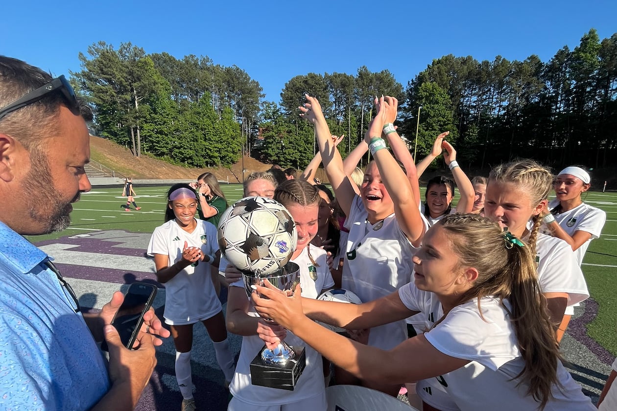 Seniors Amelia Comeaux and Reagan Michals celebrate together after Blessed Trinity beat Marist 1-0 for their second straight state championship. (Staff)