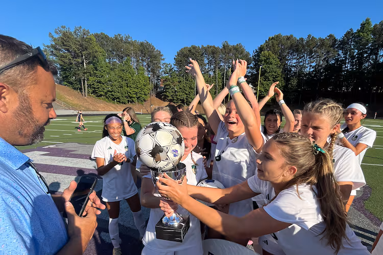 Seniors Amelia Comeaux and Reagan Michals celebrate together after Blessed Trinity beat Marist 1-0 for their second straight state championship. (Staff)