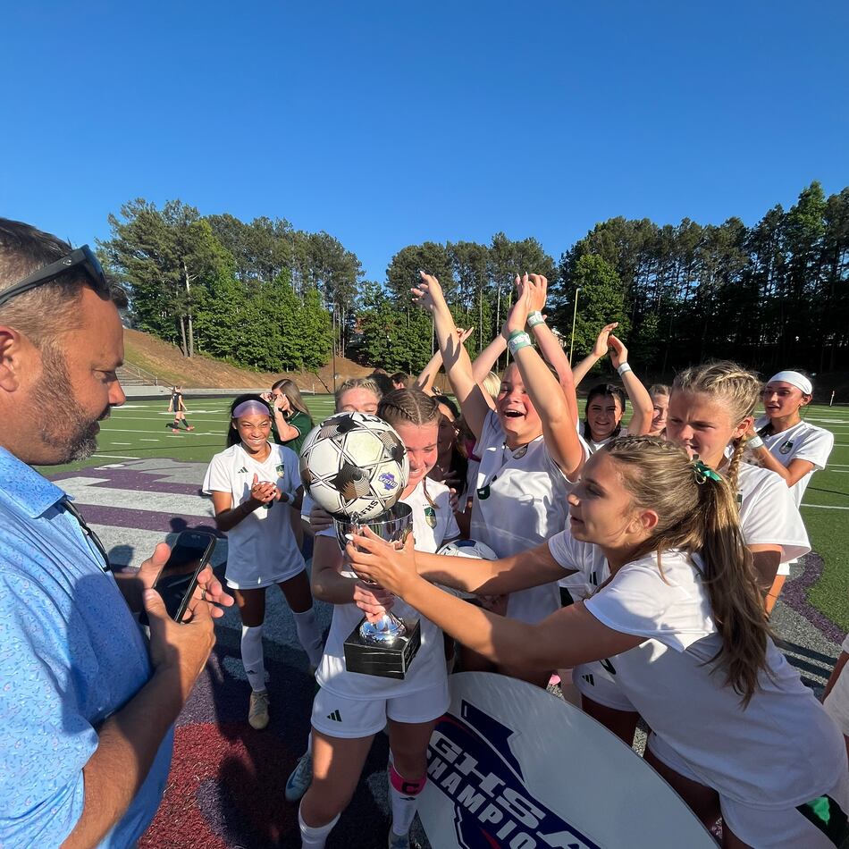 Seniors Amelia Comeaux and Reagan Michals celebrate together after Blessed Trinity beat Marist 1-0 for their second straight state championship. (Staff)