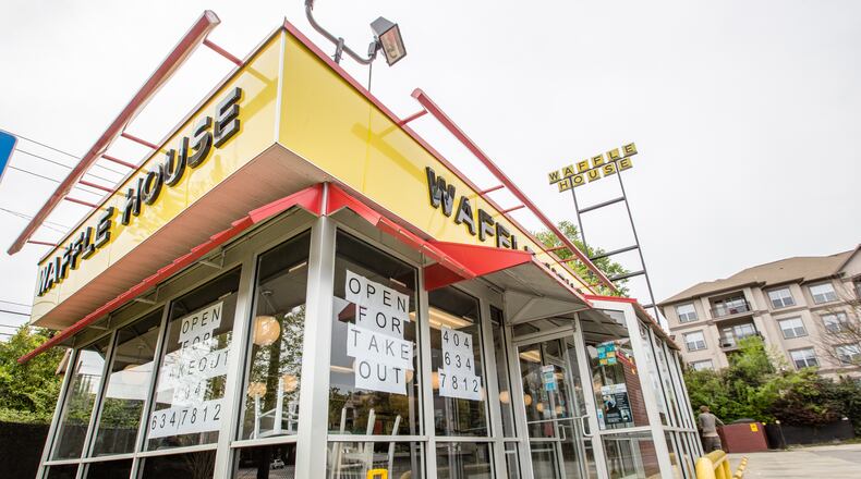 In this photo from earlier this month, Waffle House in Brookhaven has posted menus on the glass and was only open for take-out orders. (Jenni Girtman for The Atlanta Journal-Constitution)