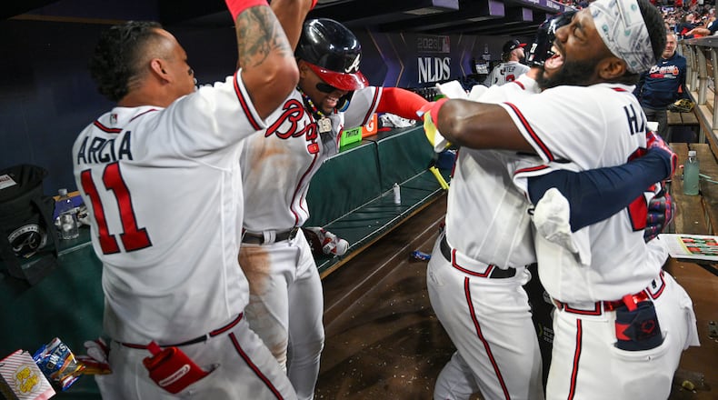 Atlanta Braves’ Orlando Arcia (11) and Michael Harris II (23) celebrate with Austin Riley after his two-run home run against the Philadelphia Phillies during the eighth inning of NLDS Game 2 in Atlanta on Monday, Oct. 9, 2023. (Hyosub Shin / Hyosub.Shin@ajc.com)