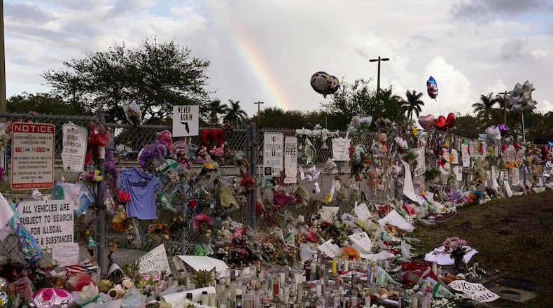 A rainbow is seen Monday over the memorial outside of Marjory Stoneman Douglas High School in Parkland Fla., the scene of a shooting that killed 14 people earlier this month. (Joe Cavaretta /South Florida Sun-Sentinel via AP)