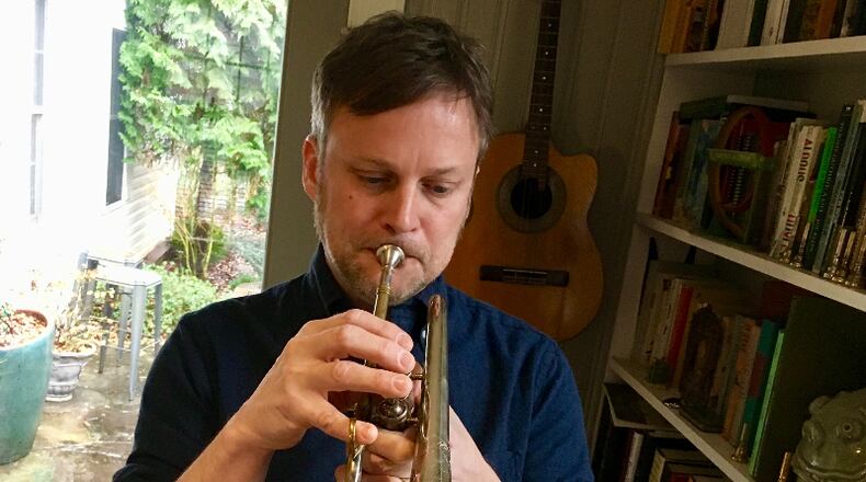 Matt Phillips playing the circa 1900 Three Star Boston cornet he restored. Bill Banks for the AJC