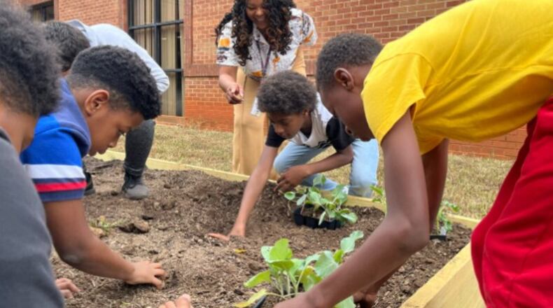 Oakland Elementary students participate in an initiative to plant and grow vegetables at their school’s community garden. (Courtesy of Henry County Schools)