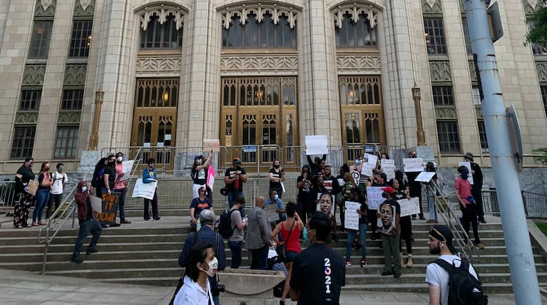 Demonstrators at City Hall react to news of Garrett Rolfe's reinstatement. Photo: Henri Hollis