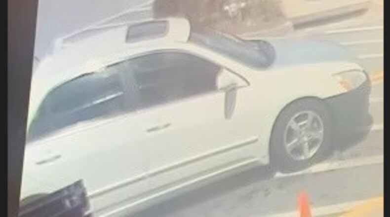 DeKalb County investigators released photos of a white Honda sedan they believe was involved in a homicide at the Emory Commons shopping center. The sedan has a black bumper, gray hood and a sunroof.