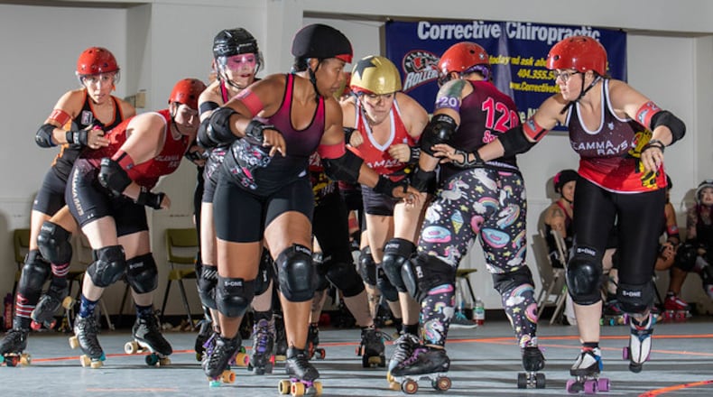 Members of Atlanta Roller Derby: (L-R) Anna Benbrook, aka Gucci Maim; Shaylyn Mackey, aka Arithrottle; Marilyn Brooks, aka Walt Hitman; Kae Mcgowan, aka Erykah Badoozie; Nikita Raper, aka Human Missile Crisis; Liz Kearney, aka Cpt. Smack Sparrow; and Ashleigh Henne, aka R2DEATH2, in action Aug. 3, 2019. (Photo by Chris Albright for Atlanta Roller Derby)