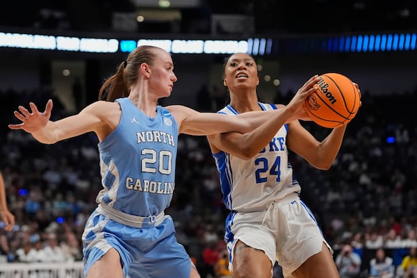 Duke guard Reigan Richardson (24) drives to the basket against North Carolina guard Lexi Donarski (20) during the second half in the Sweet 16 of the NCAA college basketball tournament, Friday, March 28, 2025, in Birmingham, Ala. (AP Photo/Gerald Herbert)