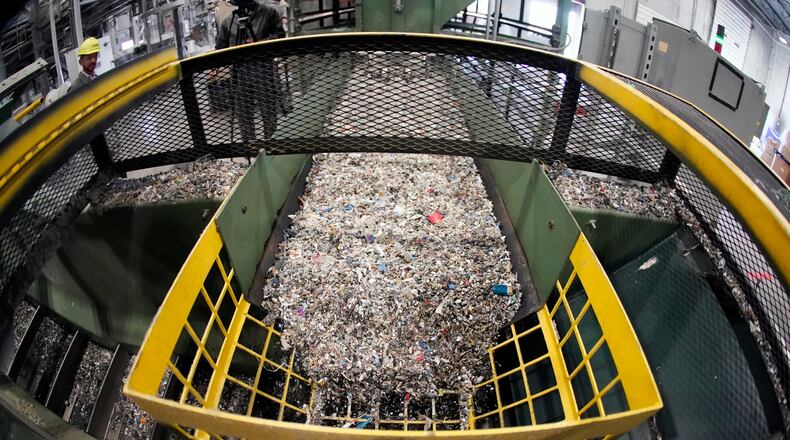 FILE - Ground up plastics that Alterra Energy receives from recycling facilities, move along a conveyor at the start of their process that transforms the material into a liquid that is then used in the manufacturing of plastic in Akron, Ohio, Sept. 8, 2022. (AP Photo/Keith Srakocic, File)