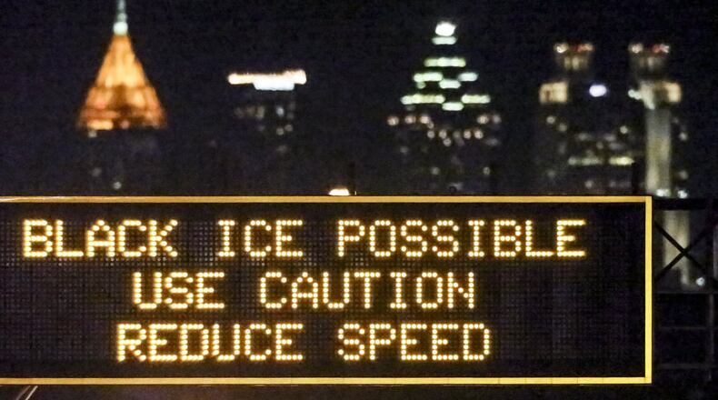Georgia Department of Transportation electronic interstate signs like the one on northbound I-85 near Sylvan Road in Fulton County warned motorists to be on the lookout for black ice. Temperatures are slowly increasing, but it didn’t feel like it Monday. Temperatures were 30 degrees in Atlanta, 19 in Blairsville and 26 in Griffin at 11:30 a.m., according to Channel 2 Action News. But the wind still made temps feel like they were in the 20s. JOHN SPINK /JSPINK@AJC.COM