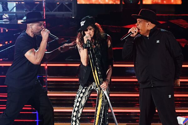 Joseph Simmons (left) of music group Run?D.M.C., Steven Tyler of music group Aerosmith, and Darryl McDaniels of music group Run?D.M.C. perform onstage during the 62nd Annual GRAMMY Awards at STAPLES Center on January 26, 2020 in Los Angeles, California. (Kevin Winter/Getty Images for The Recording Academy/TNS)