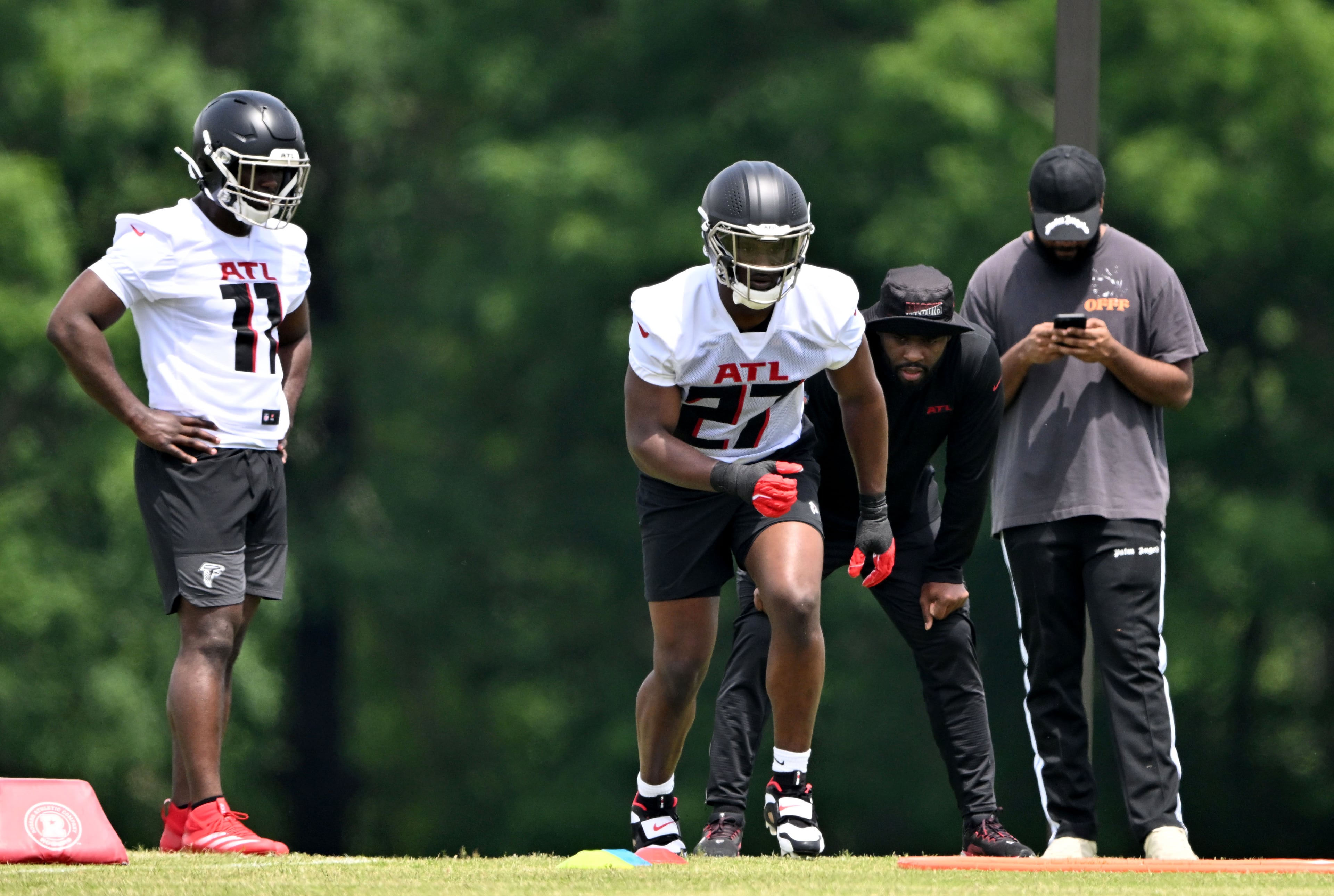 Atlanta Falcons edge rushers Jalon Walker (left) and James Pearce Jr. run a drill at the Atlanta Falcons Training Camp, Friday, May 9, 2025, in Flowery Branch. (Hyosub Shin/AJC)