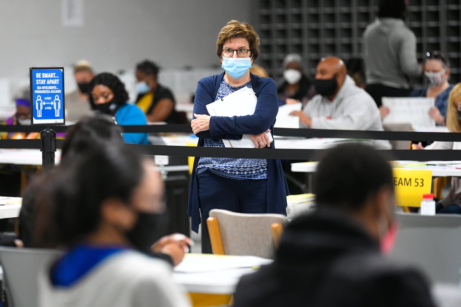 An observer monitors as votes for President are recounted at the Gwinnett County elections office on Friday, Nov.13, 2020 in Lawrenceville. (JOHN AMIS FOR THE ATLANTA JOURNAL-CONSTITUTION)