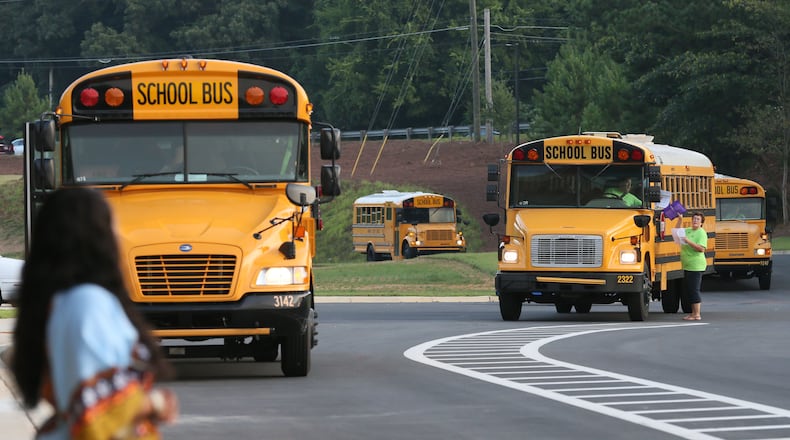 Aug. 10, 2015 - Lawrenceville - Busses arrive on the first day back at school at Baguette Elementary School in Lawrenceville. Metro Atlanta area teachers and students headed back to school on Monday. It was the first day of school in Fulton, Gwinnett and DeKalb counties. Brand new Baggett Elementary School opened in Lawrenceville with a 1,125 student capacity. BOB ANDRES / BANDRES@AJC.COM