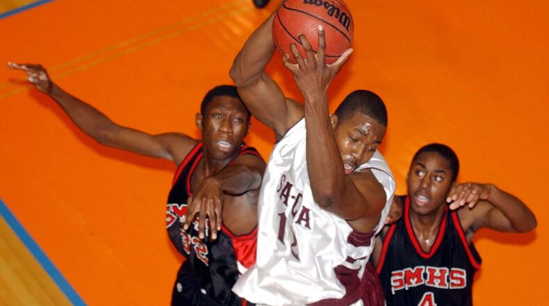 Southwest Atlanta Christian Academy’s (12) Dwight Howard goes for a rebound against Stone Mountain High School during a game on Nov. 25, 2003. AJC file photo