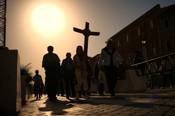 Pilgrims arrive in St. Peter's Square at the Vatican, Tuesday, April 22, 2025. (AP Photo/Francisco Seco)