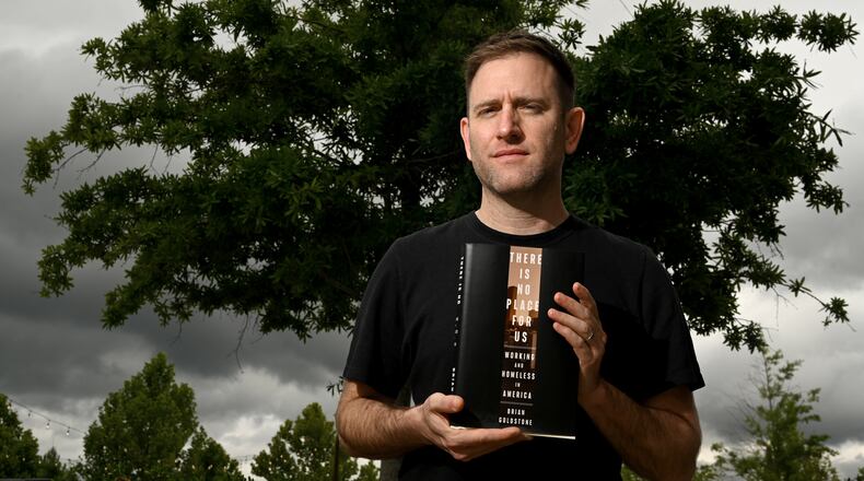 Author Brian Goldstone poses with his Pulitzer Prize-winning nonfiction book “There Is No Place For Us” in Avondale Estates. The Pulitzer website hails it as "a feat of reportage, analysis and storytelling focusing on the issues that have created a national crisis of family homelessness among the so-called working poor." (Hyosub Shin/AJC)
