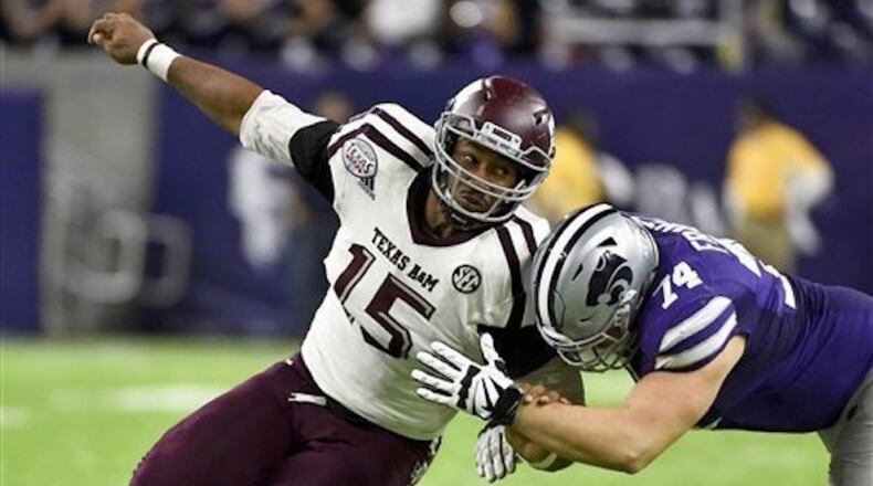 In this Dec. 28, 2016, file photo, Texas A&M's Myles Garrett (15) tries to get around Kansas State offensive lineman Scott Frantz during the second half of the Texas Bowl NCAA college football game in Houston. Elite speed, quickness and strength add up to a potentially dominant pass rusher with only the need to stay on the field more. Odds-on favorite to be No. 1 overall pick. (AP Photo/Eric Christian Smith, File)