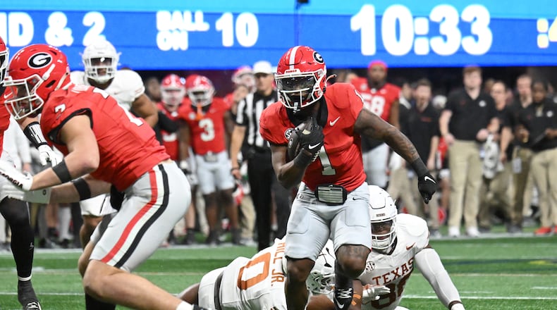 Georgia running back Trevor Etienne (1) runs for a touchdown during the second half in the SEC Championship football game at the Mercedes-Benz Stadium, Saturday, December 7, 2024, in Atlanta. Georgia won 22-19 over Texas in overtime. (Hyosub Shin / AJC)