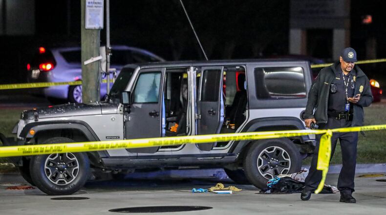 November 2, 2021 Atlanta: Atlanta police are investigating after a woman was found shot to death early Tuesday morning, Nov. 2, 2021 at a northwest Atlanta gas station. The shooting occurred along Sandy Creek Drive, but police responded to a Citgo gas station on Martin Luther King Jr. Drive shortly before 2 a.m. regarding the wounded woman. She was dead when officers arrived. Her name was not released. A gray Jeep was part of the crime scene and investigators had its doors open. Authorities did not say if the woman drove the Jeep from Sandy Creek Drive to the gas station or if she was found inside it. Police said witnesses at the gas station were cooperative but did not say if they saw the shooting. (John Spink / John.Spink@ajc.com)