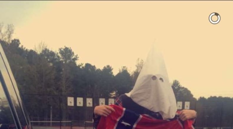 East Coweta High School officials are investigating a photograph of one of their students supposedly wearing a KKK hood.