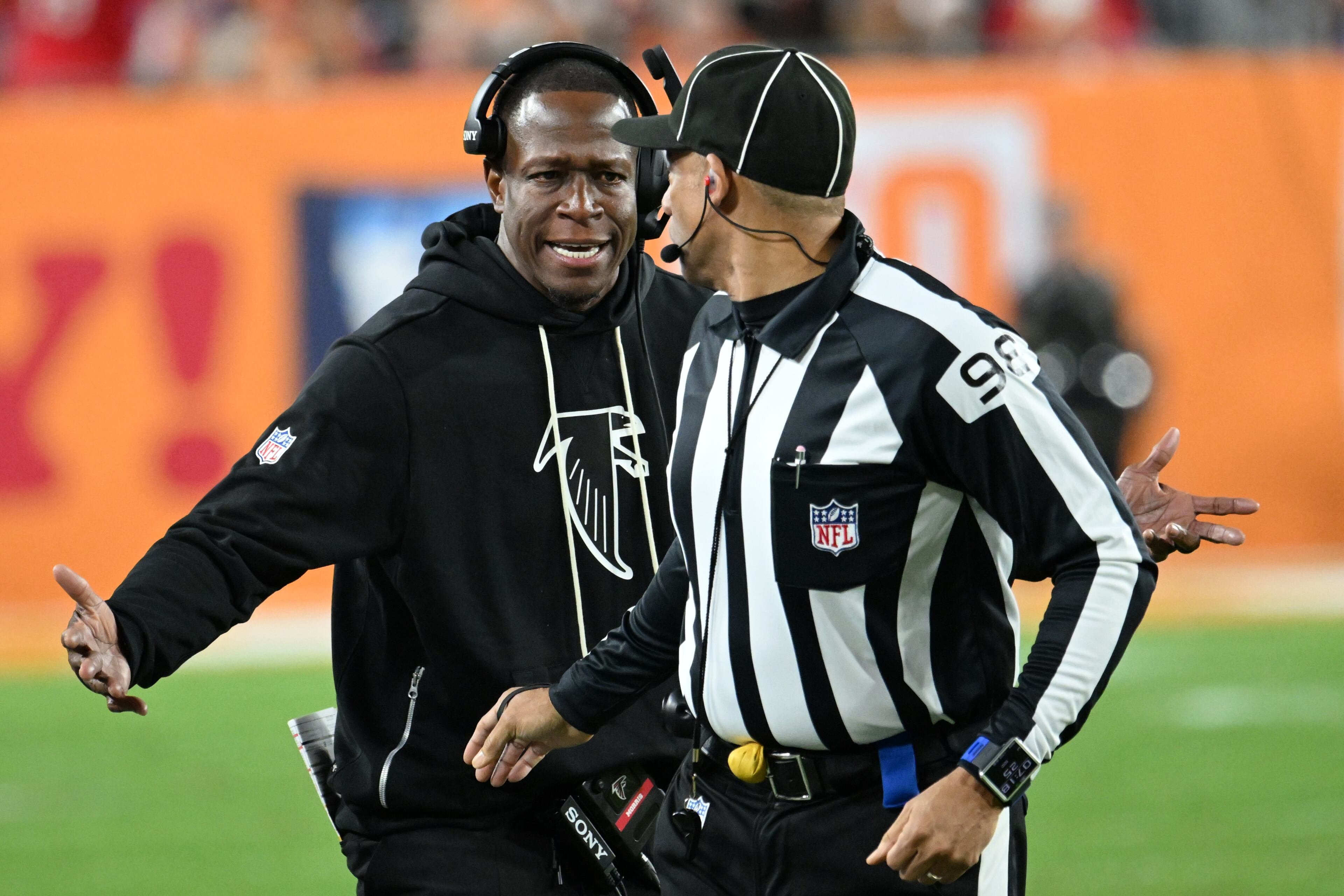 Atlanta Falcons head coach Raheem Morris speaks with line judge Greg Bradley during the second half of an NFL football game against the Tampa Bay Buccaneers, Thursday, Dec. 11, 2025, in Tampa, Fla. (AP Photo/Jason Behnken)