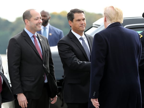 In 2019, then-Lt. Gov. Geoff Duncan (center) and Attorney General Chris Carr greeted President Donald Trump (right) as he arrived in Marietta. (AJC file photo)